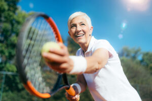 woman serving a tennis ball