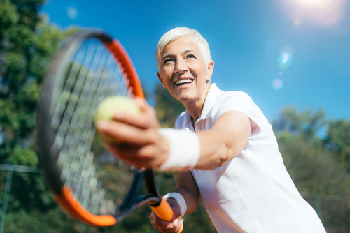 Older woman playing tennis